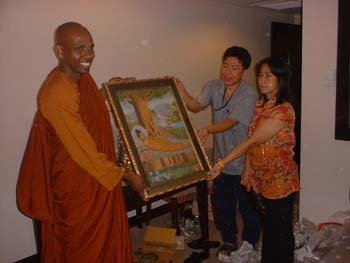 International Vesak day in Thiland 2006 - offering a Buddha's picture
